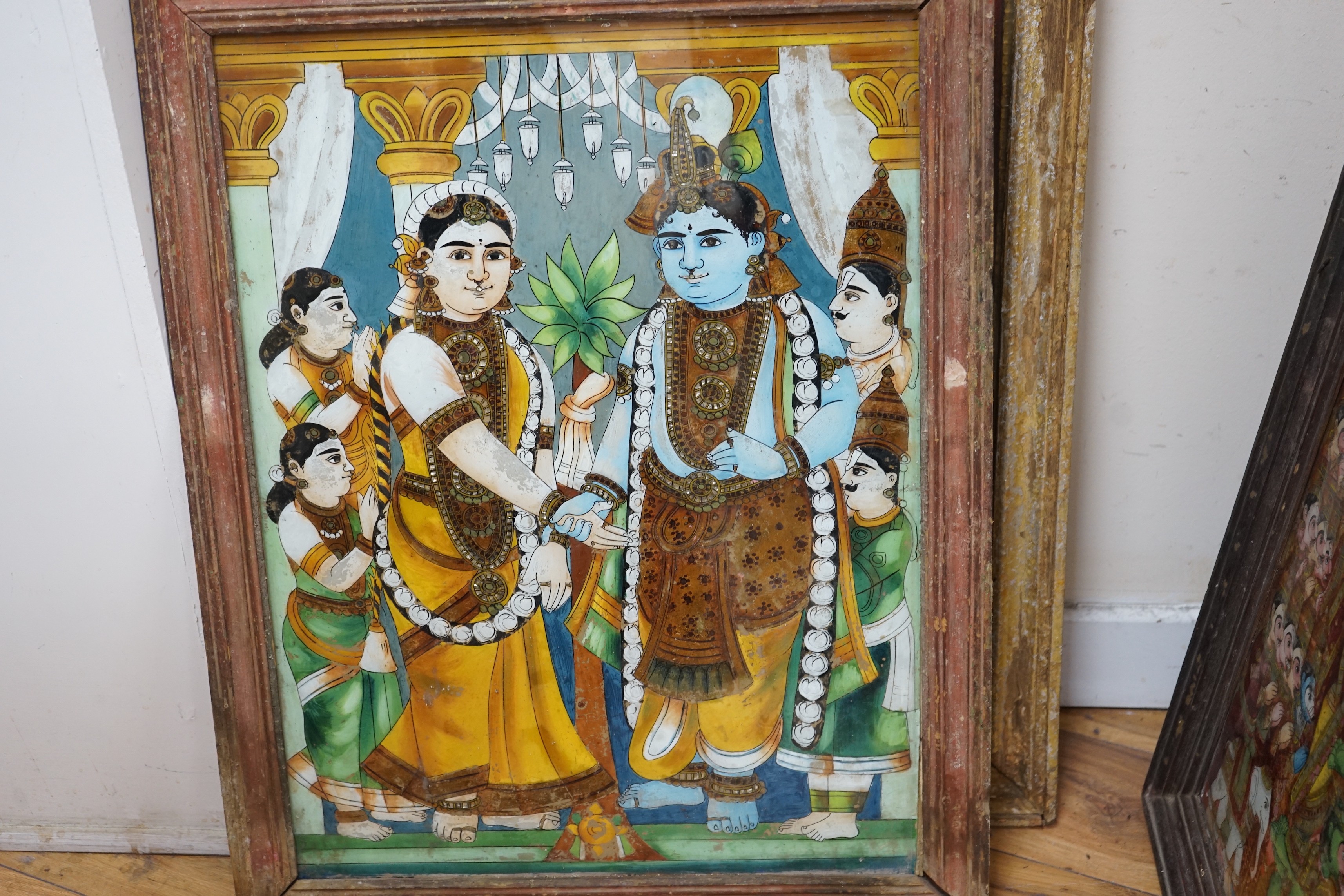 A collection of eight Indian reverse decorated glass pictures, 20th century, largest frame 70cm X 60cm